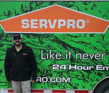 Photo of SERVPRO of Spencer & Iowa Great Lakes Production Manager Nick VonEhwegen standing next to company trailer. 