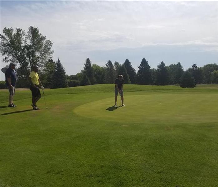 Three local first responders golfing 